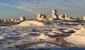 Desert landscape with unique rock formations at sunset.