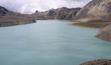 Large glacial lake with surrounding mountains in a remote area.