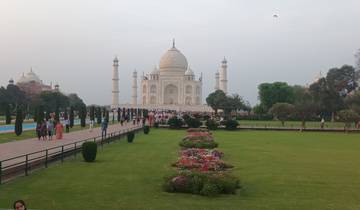 The Taj Mahal with gardens and visitors.