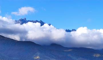 Mountain range with peaks above the clouds on a clear day.