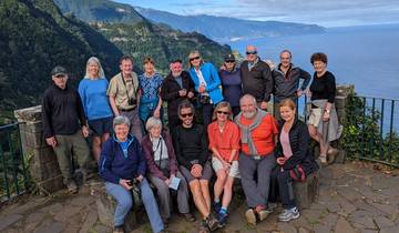 Group of people posing with a scenic ocean view.