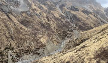 Remote mountainous landscape with paths visible.