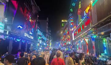 Bustling nightlife scene with illuminated signs.