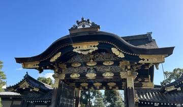 Ornate gate with gold decorations against blue sky.