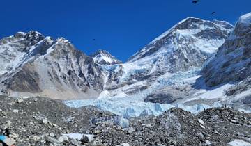 Vast snowy mountain peaks under a clear blue sky.