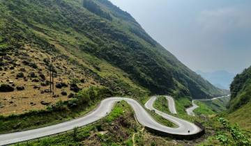Winding road through hilly terrain with a motorbike.