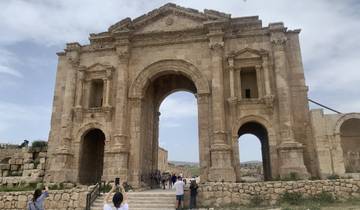 Visitors exploring the ancient Arch of Hadrian.