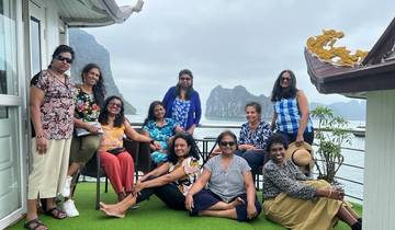 Group of women posing on a deck with limestone mountains in the background