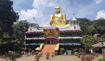 Golden Buddha statue in front of a temple entrance.