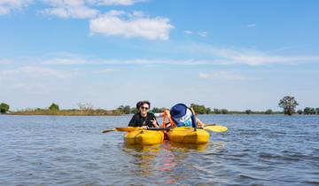 Two people kayaking on a lake.