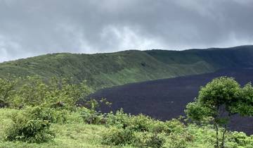 Lush green hills with a contrasting dark lava field.