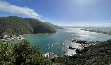 Scenic view of a bay with green hills and blue water.