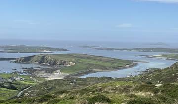 Scenic landscape with rolling hills and water.