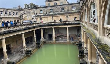Historic Roman Baths with people walking around.