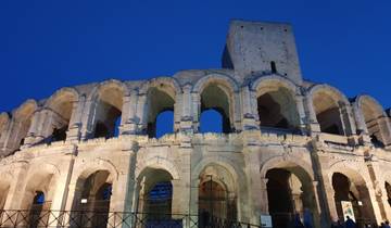 Roman amphitheater illuminated at night.