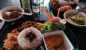 Assorted Sri Lankan dishes with rice, curry, and vegetables.