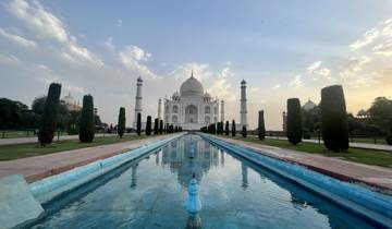 Symmetrical view of the Taj Mahal with reflective pool in the foreground.