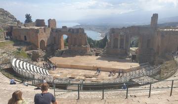 Ancient ruins with a sea view in the background.