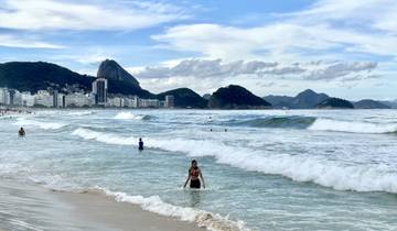 Beach with waves and people enjoying the water.