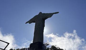 Silhouette of the Christ the Redeemer statue against the sky.