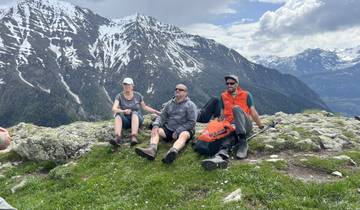 Hikers resting with snowy mountain backdrop.
