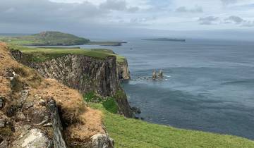 Coastal cliffs with grassland, likely in Scotland.
