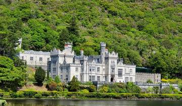 Scenic view of a castle amidst lush green hills.