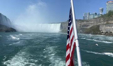 Niagara Falls viewed from a boat with the American flag.