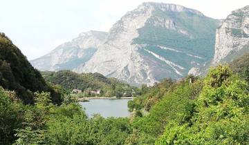 Distant mountains with dense forest and a lake in the foreground.