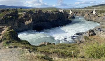 A powerful river flowing through a rugged canyon landscape.