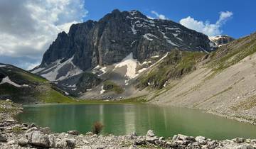 Mountainous landscape surrounding a lake.