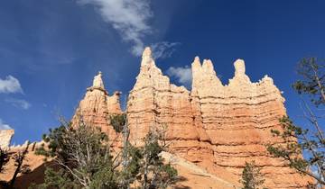 Hoodoo rock formations under a blue sky.