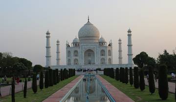 Taj Mahal with reflection in a pool during the day.