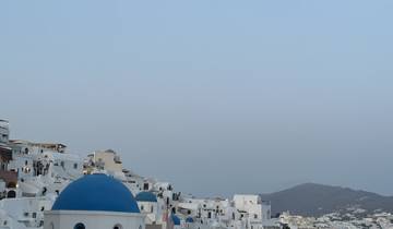 Scenic view of Santorini with blue-domed churches and white buildings.