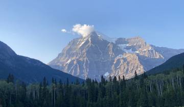Majestic view of Mount Robson with surrounding forest.