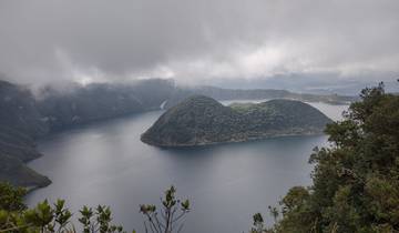 Scenic view of a lake with an island covered in greenery.