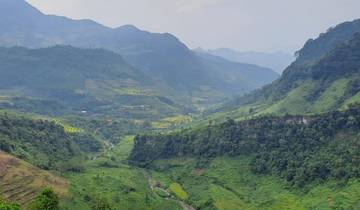 Panoramic view of a lush green mountain valley.