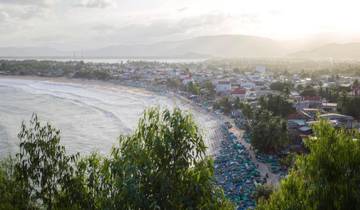 Panoramic view of a coastal town with a sandy beach.