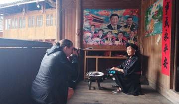 Photographer capturing an elderly woman in a traditional home