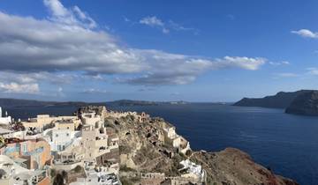 Stunning view of Santorini with white buildings overlooking deep blue sea.