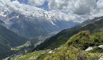 A vast mountain range with valleys filled with greenery.