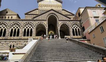 Ornate church facade with steps and people.