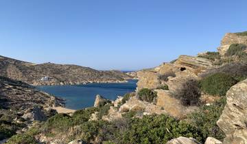 Rocky coastline with a small bay and clear skies.