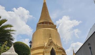 A golden pagoda with a blue sky and clouds.