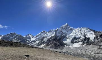 Snow-topped mountains under a bright sun.