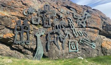 Rock face with carved artwork.