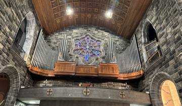 A church interior with a magnificent stained glass window.