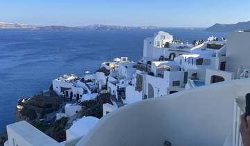 White-washed buildings on cliffs overlooking the Aegean Sea.
