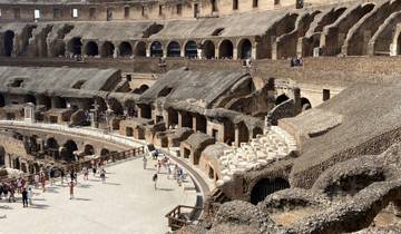 Interior view of the Colosseum with tourists.