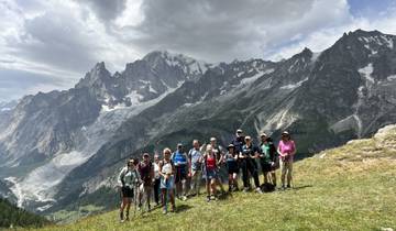 Hikers posing with a background of mountains.